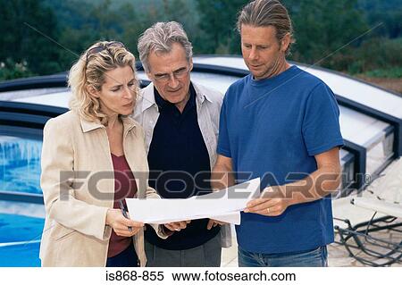 Stock Photography - People looking at plans. Fotosearch