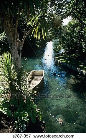 Boat on a river in christchurch new zealand View Large Photo Image Stock Photo - Boat on a river in christchurch new zealand. Fotosearch