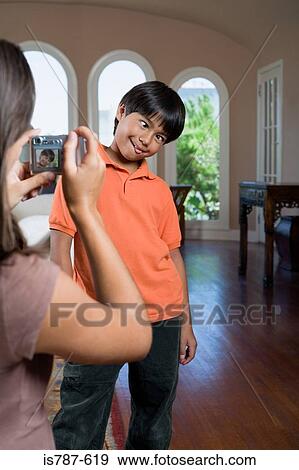Girl taking picture of brother View Large Photo Image Stock Photo - Girl taking picture of brother. Fotosearch