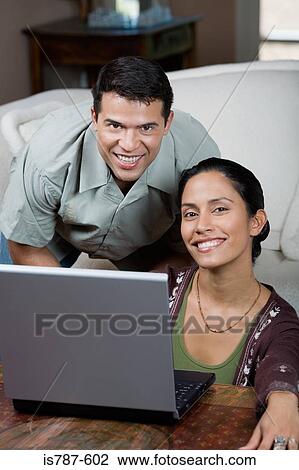 Stock Image - Man and woman with laptop. Fotosearch