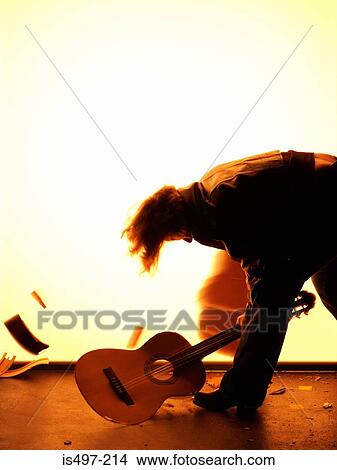Man smashing guitar View Large Photo Image Picture - Man smashing guitar. Fotosearch