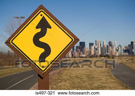 Stock Image - Road sign and cityscape. Fotosearch