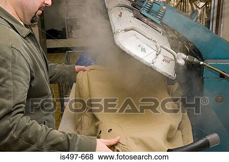 Stock Photo - Man using trouser press. Fotosearch
