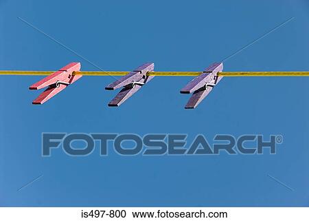 Stock Image - Pegs on a clothesline. Fotosearch