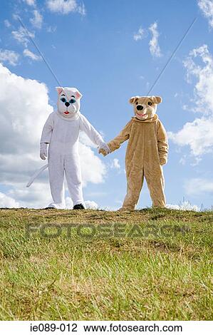 People in cat and dog costumes holding hands View Large Photo Image Stock Image - People in cat and dog costumes holding hands. Fotosearch