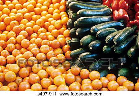 Stock Image - Peppers courgettes and oranges. Fotosearch