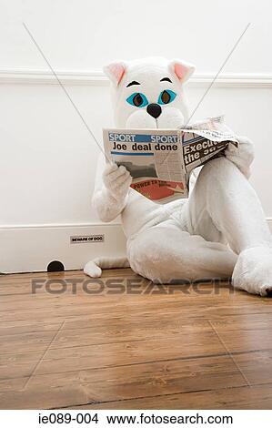 Picture - Person in cat costume reading newspaper. Fotosearch