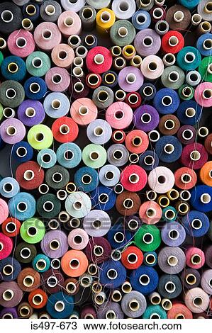 Stock Image - Pile of cotton reels. Fotosearch