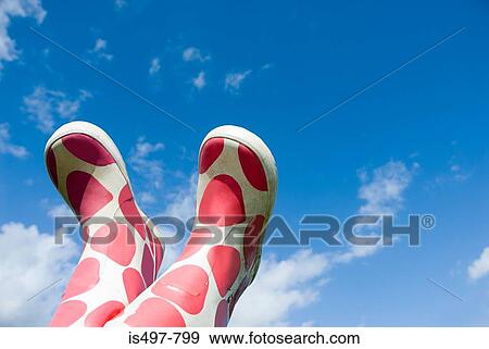 Stock Photo - Rubber boots in the air. Fotosearch