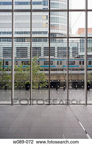 Stock Image - Train going through city. Fotosearch