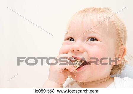A baby boy eating a biscuit View Large Photo Image Stock Photo - A baby boy eating a biscuit. Fotosearch