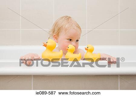 A baby boy looking at a row of rubber ducks View Large Photo Image Stock Photo - A baby boy looking at a row of rubber ducks. Fotosearch