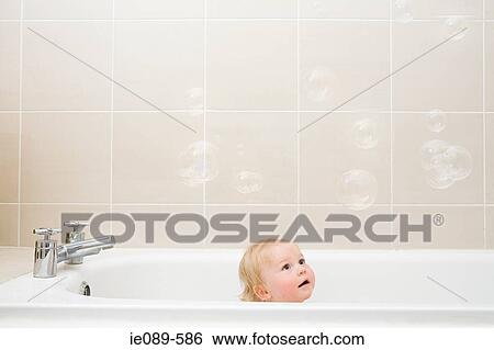 A baby boy looking at bubbles View Large Photo Image Stock Photograph - A baby boy looking at bubbles. Fotosearch