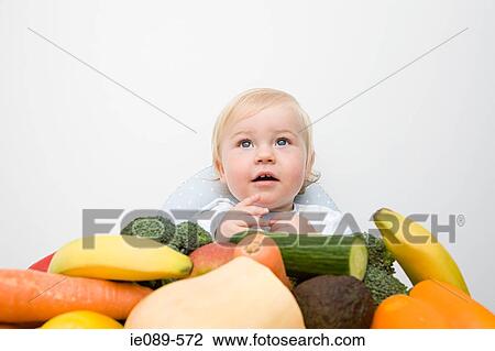 A portrait of a baby boy and a pile of vegetables View Large Photo Image Stock Image - A portrait of a baby boy and a pile of vegetables. Fotosearch