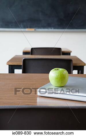 Apple and laptop on a desk View Large Photo Image Stock Image - Apple and laptop on a desk. Fotosearch