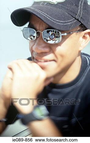 Man in sunglasses and cap View Large Photo Image Stock Photograph - Man in sunglasses and cap. Fotosearch