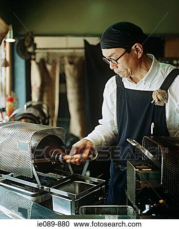 Stock Image - Man roasting coffee beans. Fotosearch