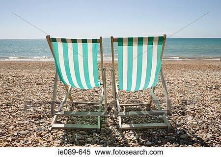 Two deck chairs on a beach View Large Photo Image Stock Photography - Two deck chairs on a beach. Fotosearch