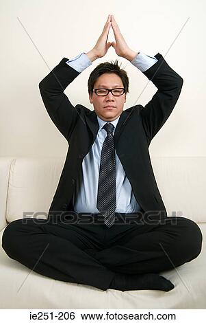 A businessman meditating View Large Photo Image Stock Photograph - A businessman meditating. Fotosearch