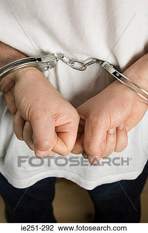 A criminal wearing handcuffs View Large Photo Image Stock Image - A criminal wearing handcuffs. Fotosearch