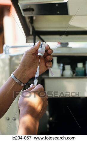 A doctor holding a needle View Large Photo Image Stock Photo - A doctor holding a needle. Fotosearch