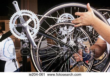 A factory worker checking a bicycle wheel View Large Photo Image Stock Image - A factory worker checking a bicycle wheel. Fotosearch