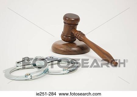 Picture - A gavel and handcuffs. Fotosearch