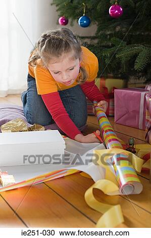 A girl cutting wrapping paper View Large Photo Image Stock Image - A girl cutting wrapping paper. Fotosearch