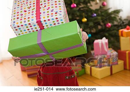 A girl holding a present View Large Photo Image Picture - A girl holding a present. Fotosearch