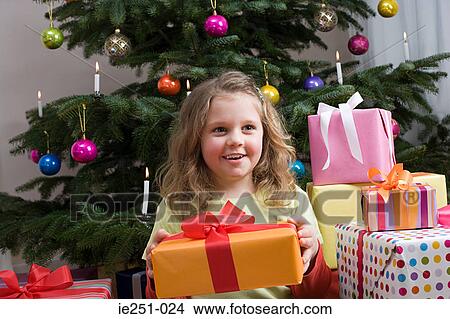 A girl holding a present View Large Photo Image Picture - A girl holding a present. Fotosearch