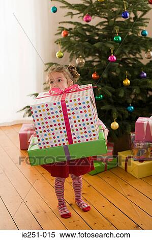 A girl holding a present View Large Photo Image Stock Photography - A girl holding a present. Fotosearch