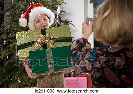 Stock Image - A girl photographing her brother. Fotosearch