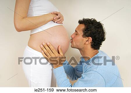 A man kissing a pregnant womans stomach View Large Photo Image Stock Photo - A man kissing a pregnant womans stomach. Fotosearch
