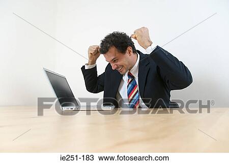 An elated businessman View Large Photo Image Stock Image - An elated businessman. Fotosearch