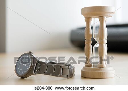 An hourglass and a watch View Large Photo Image Stock Image - An hourglass and a watch. Fotosearch