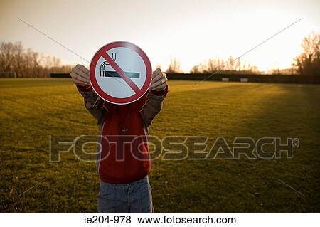 Stock Photo - Boy holding a no smoking sign. Fotosearch