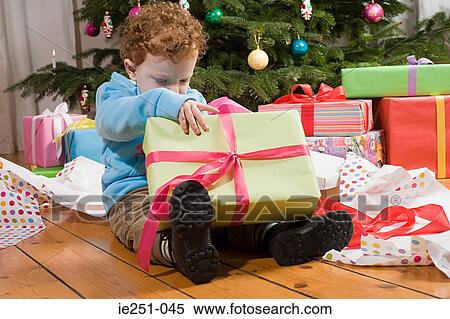 Boy opening christmas presents View Large Photo Image Stock Photography - Boy opening christmas presents. Fotosearch