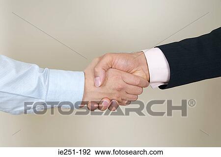 Stock Image - Businessmen shaking hands. Fotosearch