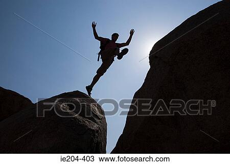 Man jumping chasm View Large Photo Image Stock Image - Man jumping chasm. Fotosearch
