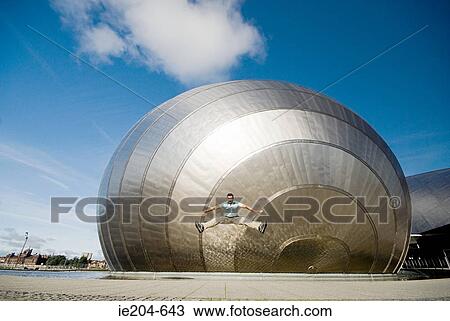 Man jumping in front of glasgow science centre View Large Photo Image Stock Image - Man jumping in front of glasgow science centre. Fotosearch