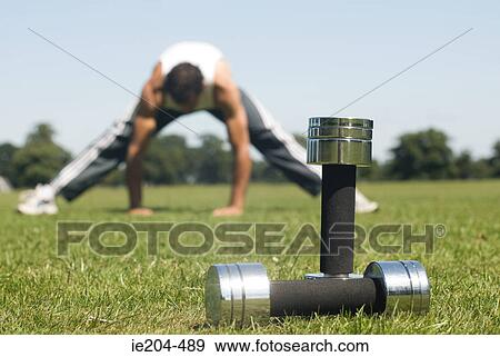 Man stretching and dumbbells View Large Photo Image Stock Photo - Man stretching and dumbbells. Fotosearch