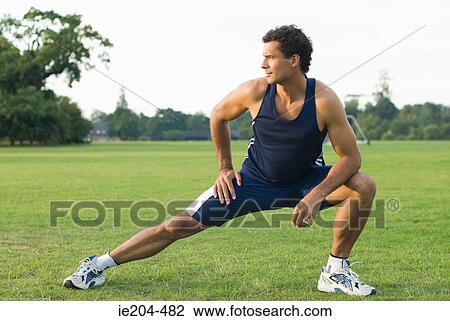 Man stretching in park View Large Photo Image Stock Image - Man stretching in park. Fotosearch