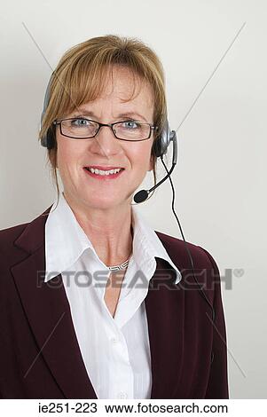 Stock Image - Portrait of a businesswoman wearing a headset. Fotosearch
