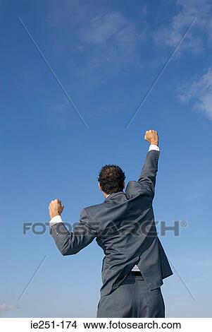 Rear view of a businessman with his arms raised View Large Photo Image Picture - Rear view of a businessman with his arms raised. Fotosearch