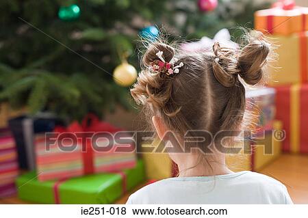 Rear view of a girl gifts and christmas tree View Large Photo Image Stock Photo - Rear view of a girl gifts and christmas tree. Fotosearch