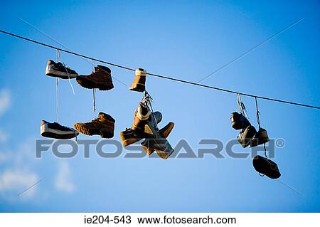 Shoes hanging from power line View Large Photo Image Stock Image - Shoes hanging from power line. Fotosearch