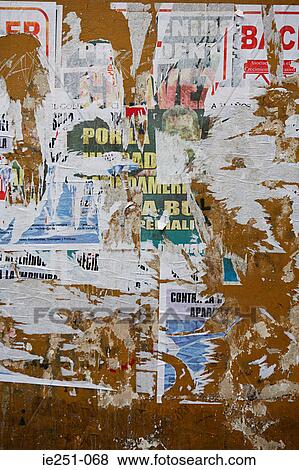 Stock Photo - Torn posters on wall. Fotosearch