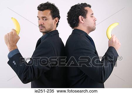 Two businessmen holding bananas as guns View Large Photo Image Stock Photography - Two businessmen holding bananas as guns. Fotosearch