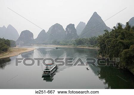 Stock Photo - Boat on lijiang river. Fotosearch