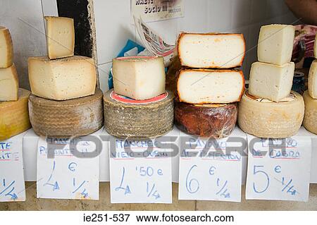 Stock Photo - Cheese on a market stall. Fotosearch